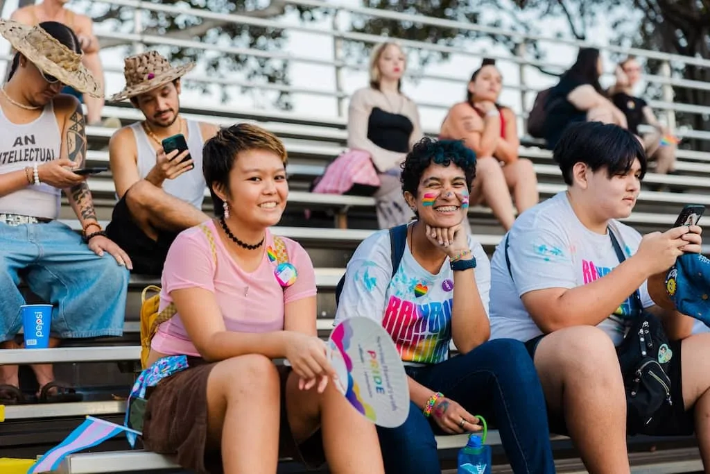 Parade attendees sitting on bleachers